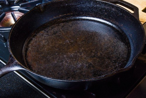 cast iron on stove - shutterstock_653170420